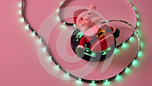 crochet christmas snowman on white background with usb led lights on the scroll, flashing and static red, blue, green