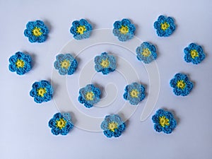 Crochet daisy flowers pattern blue floral white background texture