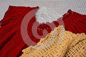 Crochet dresses and table tops, view of yarn ball and needle along with crochet patterns