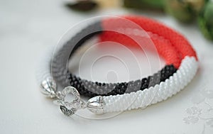 Crochet necklace of red, white and black color