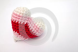 Crochet varicolored heart shape made from yarn isolated on white background.