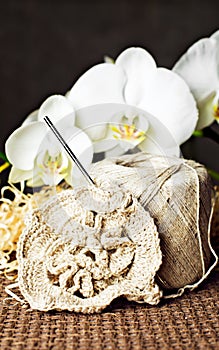 Crochet work, skeins of yarn & white orchids