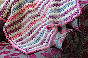 Crocheted blanket on chaise