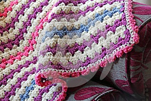 Crocheted blanket on chaise