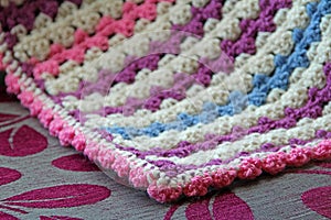 Crocheted blanket on chaise