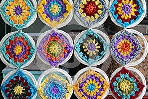 Crocheted flowers hanging on wall