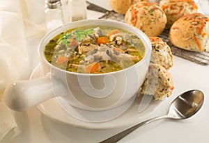 Crock of chicken and wild rice soup with herb rolls