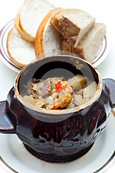 Crock pot full of beef and potato soup photo