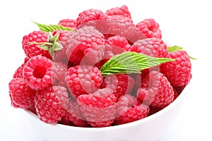 Crockery with beautiful ripe raspberries photo