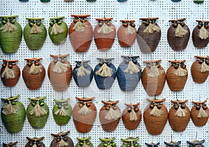 Crockery magnet pots with roes, in rows, on the wall