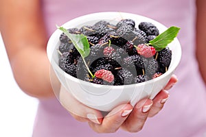 Crockery with mulberries. photo