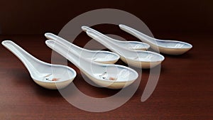 crockery spoon isolated on brown background close image