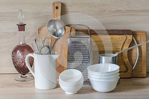 Crockery, tableware, utensils and other different stuff on wooden table-top.Kitchen still life as background for design.