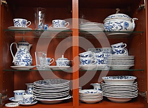 Crockery in wooden kitchen cabinet