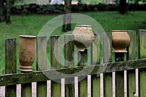 Crocks on the wooden fence