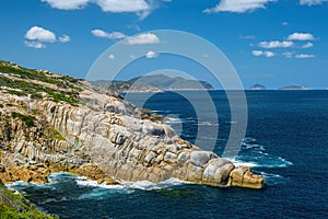 Crocodile rocky outcrops breaking ocean waves