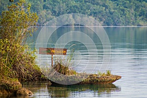 Crocodile warning sign at Laguna Lachua lake, Guatema photo