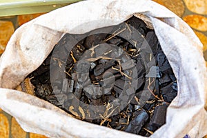 Crocus bag of coal, a hard rock burned as solid fossil fuel which is mostly carbon but has hydrogen, sulphur, oxygen and nitrogen.