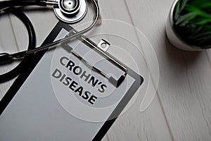 Crohn`s Disease write on a paperwork isolated on wooden table. medical concept