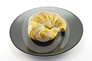 Croissant on a Black Plate