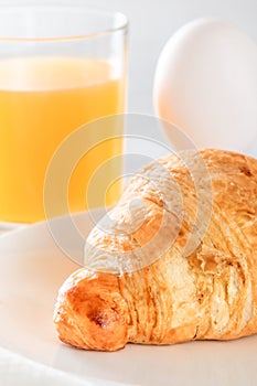 Croissant, boiled egg and freshly squeezed juice