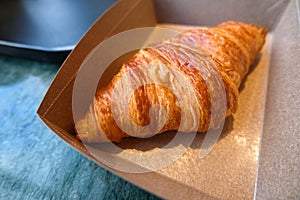 Croissant in the box on coffee break time