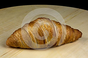 Croissant Bread Roll on a Circular Wooden Platter