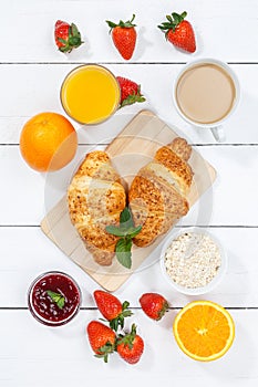 Croissant breakfast croissants orange juice coffee food wooden board from above portrait format