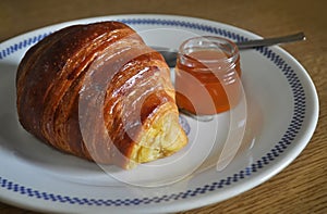 Croissant, Briochem sweet bun with small jar of apricot jam