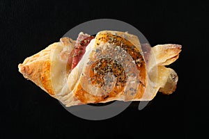 Croissant with cheese and ham. Black background photo