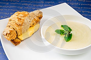 Croissant with cheese and porridge with mint