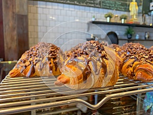 Croissant With Chocolate Chip Topping at cafe with blurred background