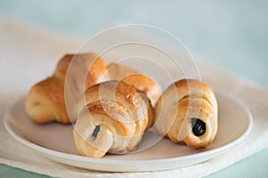 Croissant with chocolate on porcelain sauser