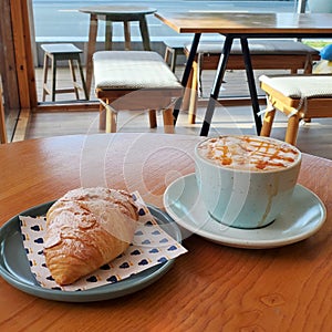 Croissant and coffee on the table at a cafe