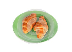 croissant in the green plate isolated on white