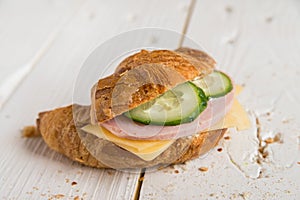 Croissant with ham, cheese and cucumber