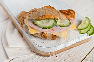 Croissant with ham, cheese and cucumber