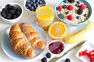 Croissant and healthy breakfast on white table photo