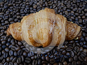 Croissant pastry on coffee bean
