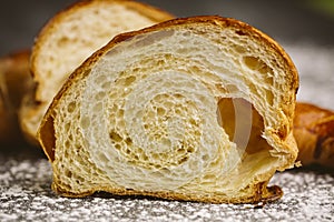 Croissant placed on a plate on a dark background.