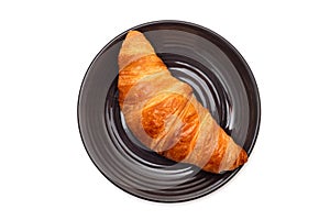 Croissant in a plate isolated on white background. Top view.
