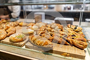 Croissant, puffs and other pastries. Showcase desserts in an Italian cafe or trattoria. Variety of cakes on display.