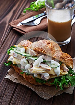 Croissant sandwich with chicken, cheese, cucumber