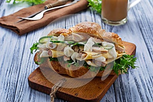 Croissant sandwich with chicken, cheese, cucumber