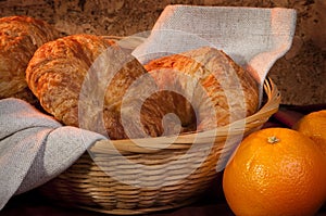 Croissant served for breakfast orange fruit
