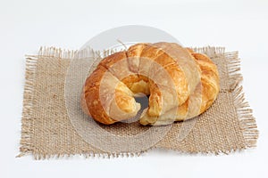 Croissant on spuare frayed burlap