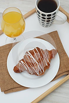 Croissant White Chocolate Breakfast Morning on white background. Cup of Tea or coffee. Rustic Style. Orange Juice. Top view. copy