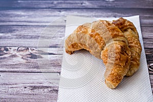 A croissant on a white napkin on a table photo