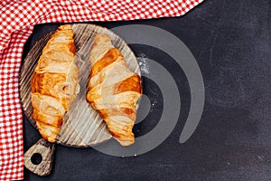 Croissant on wooden board, view