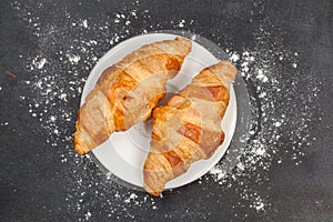 Croissant on wooden board, view